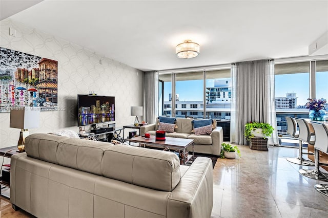 living area with a wall of windows and wallpapered walls