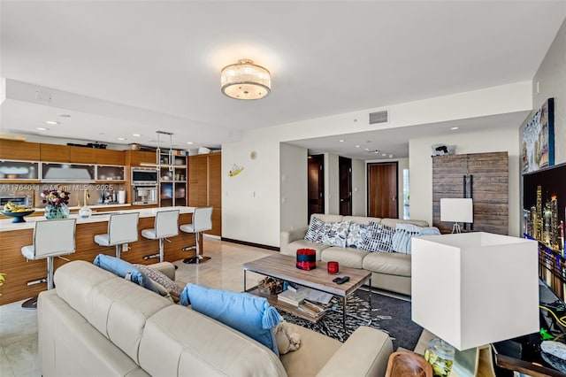 living area with recessed lighting, visible vents, and baseboards