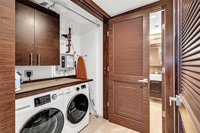 washroom with cabinet space, electric panel, and separate washer and dryer