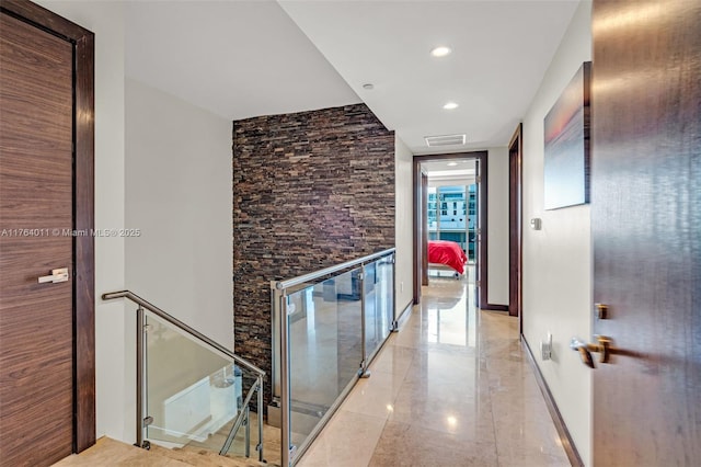 hall with recessed lighting, an upstairs landing, visible vents, and baseboards