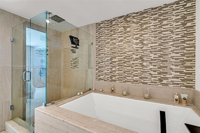 full bath featuring a stall shower, tile walls, and a garden tub