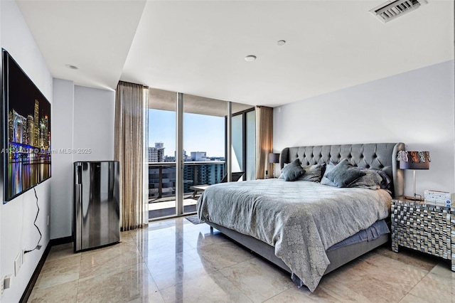 bedroom featuring access to exterior, visible vents, a view of city, and expansive windows