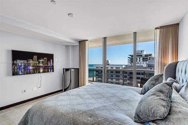 tiled bedroom with baseboards, a view of city, and floor to ceiling windows