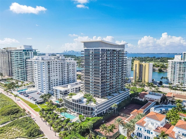 birds eye view of property featuring a city view and a water view