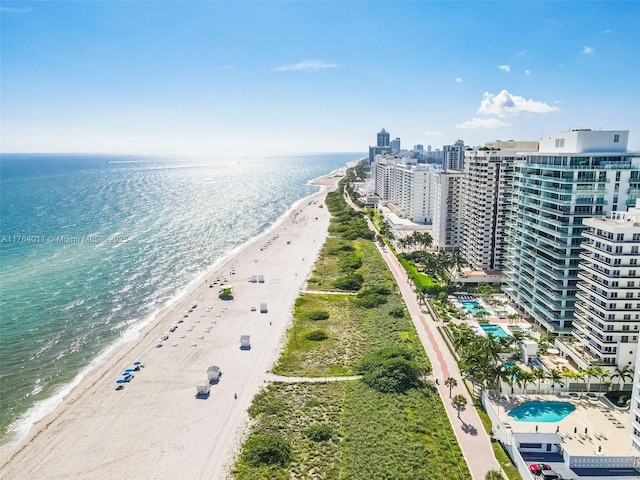 bird's eye view featuring a water view, a view of city, and a view of the beach