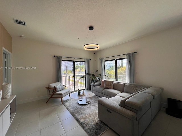 8001 NW 41st St Unit F-207, Doral, FL 33166 - living area featuring plenty of natural light, baseboards, and light tile patterned floors