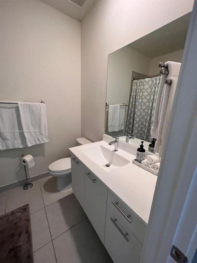 bathroom with visible vents, toilet, tile patterned flooring, baseboards, and vanity