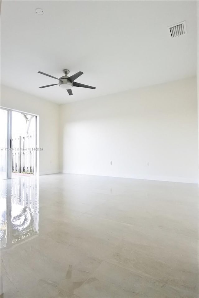 spare room with visible vents and a ceiling fan