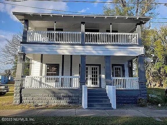 view of front of home with a balcony and covered porch