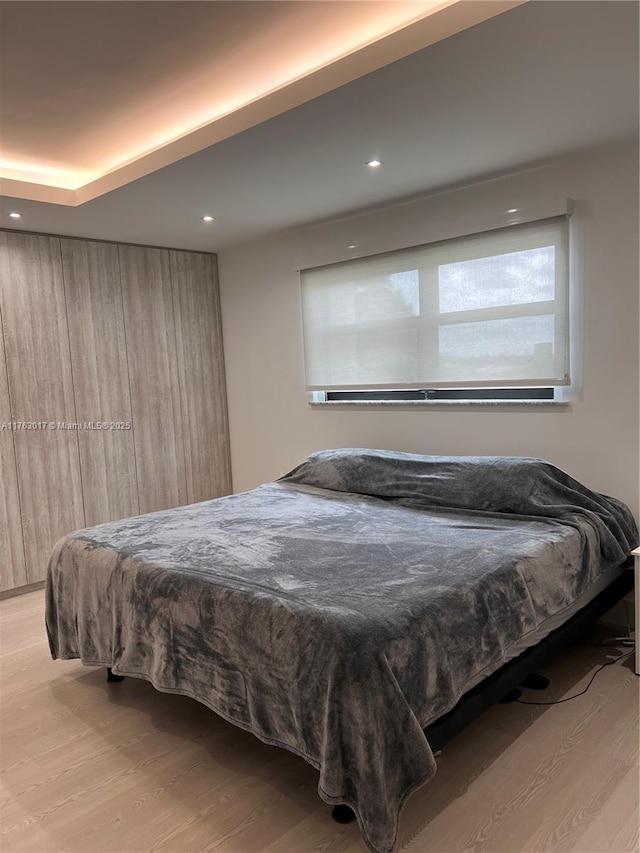 bedroom featuring recessed lighting and wood finished floors