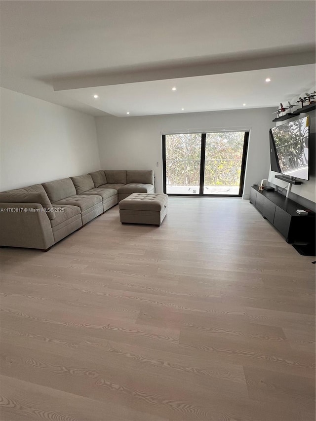 unfurnished living room with recessed lighting and wood finished floors