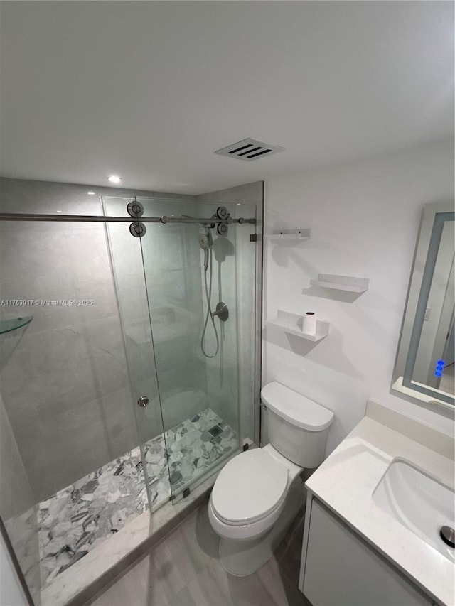 bathroom with vanity, recessed lighting, toilet, a shower stall, and visible vents