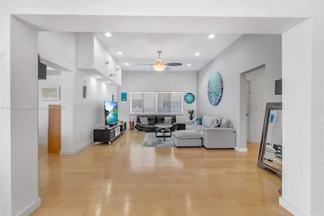 living area with light wood finished floors, recessed lighting, baseboards, and ceiling fan