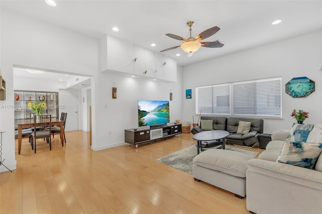 living area with recessed lighting, a ceiling fan, baseboards, and light wood finished floors