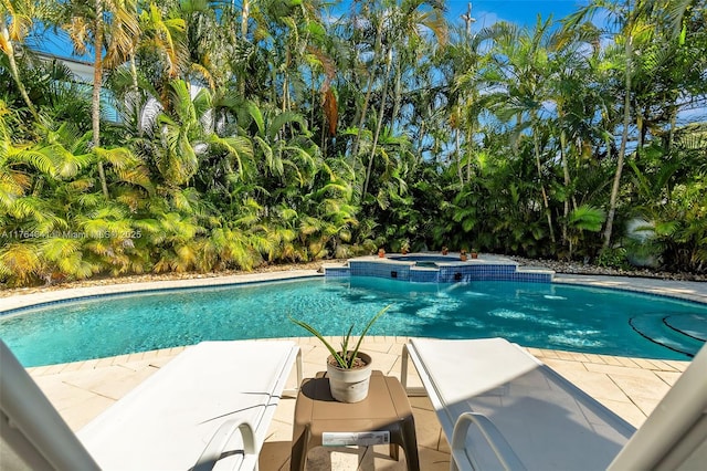 view of swimming pool with a pool with connected hot tub and a patio area