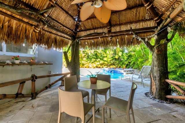 view of patio featuring a gazebo, an outdoor pool, and ceiling fan