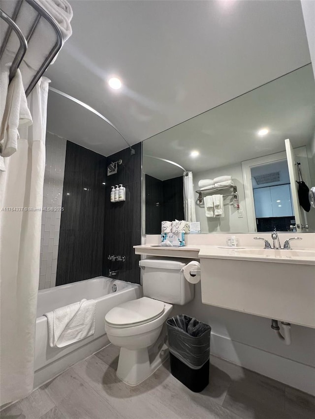 full bathroom with recessed lighting, toilet, shower / bath combo, and vanity