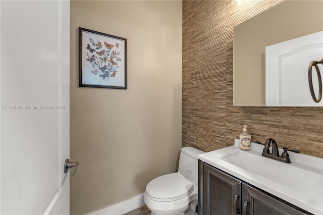 half bathroom featuring toilet and vanity