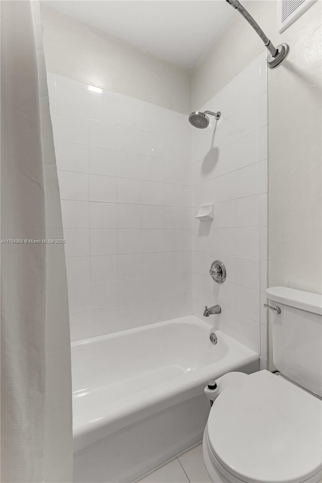 bathroom featuring visible vents, toilet, shower / bath combo, and tile patterned flooring