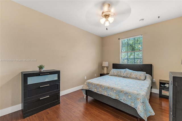 bedroom with ceiling fan, baseboards, and wood finished floors