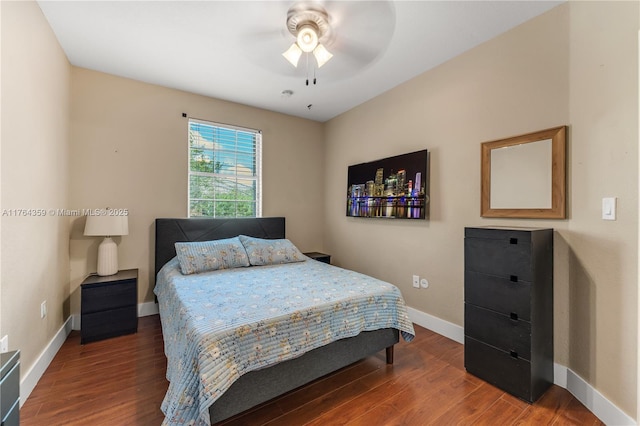 bedroom featuring a ceiling fan, wood finished floors, and baseboards