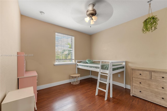 bedroom featuring wood finished floors, baseboards, and ceiling fan