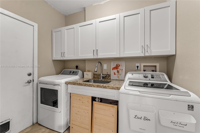 laundry room with a sink, cabinet space, and washing machine and clothes dryer