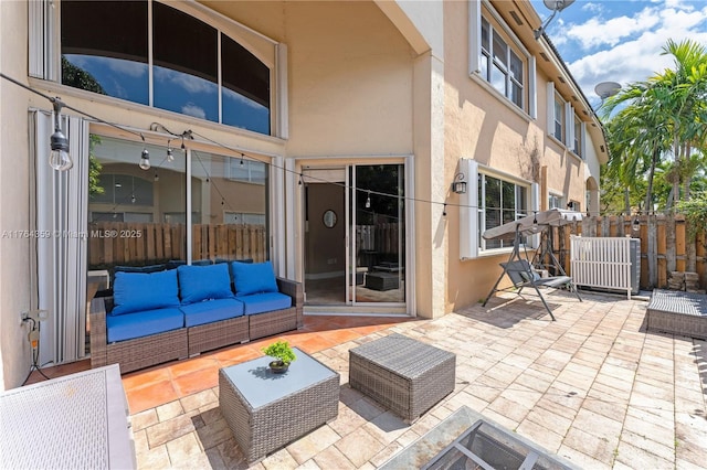 view of patio / terrace featuring an outdoor living space and fence