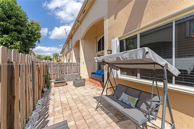 view of patio / terrace with an outdoor living space and fence