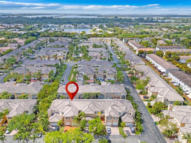 birds eye view of property with a residential view and a water view