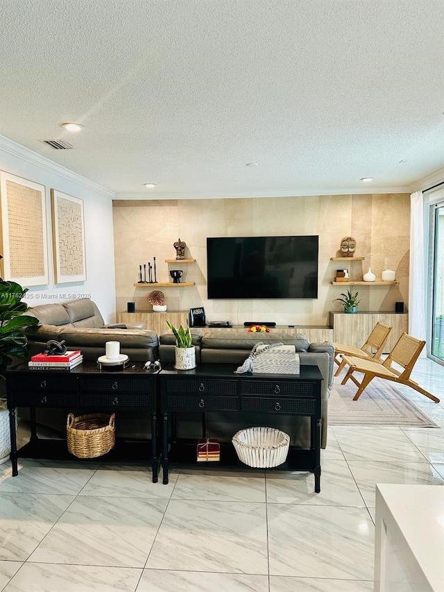 living area with a textured ceiling, visible vents, marble finish floor, and ornamental molding