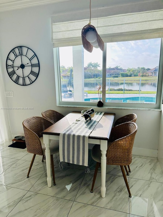 dining space featuring marble finish floor and baseboards