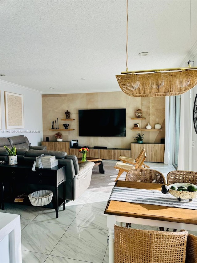 living area featuring marble finish floor, a textured ceiling, and crown molding