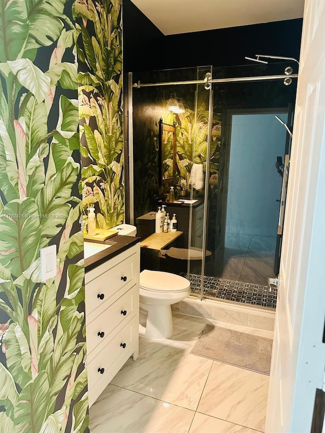 full bathroom with vanity, a shower stall, toilet, and marble finish floor