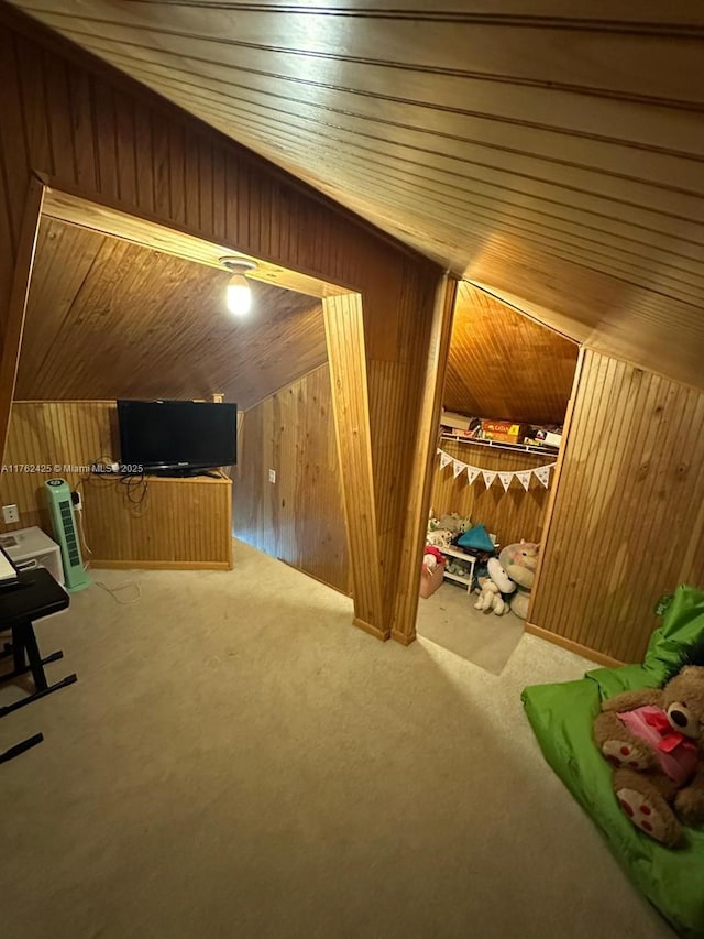 bonus room featuring lofted ceiling, wooden ceiling, wooden walls, and carpet floors