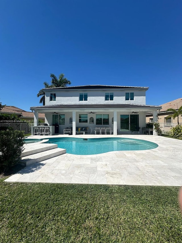 pool with a patio area and fence