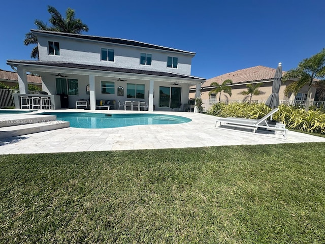 rear view of property with a patio area, a lawn, ceiling fan, and fence