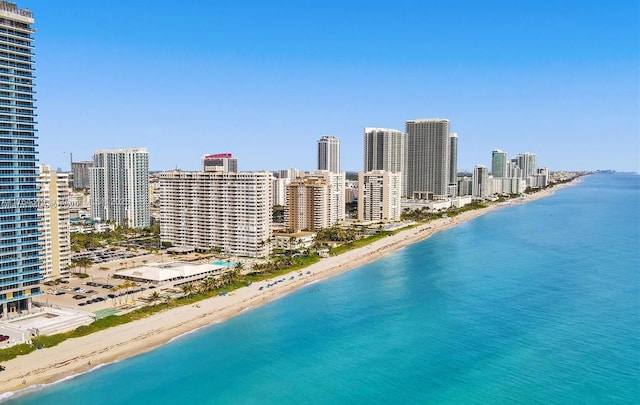 bird's eye view featuring a view of city, a water view, and a beach view