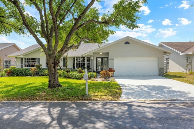 single story home with a garage, concrete driveway, a front lawn, and stucco siding