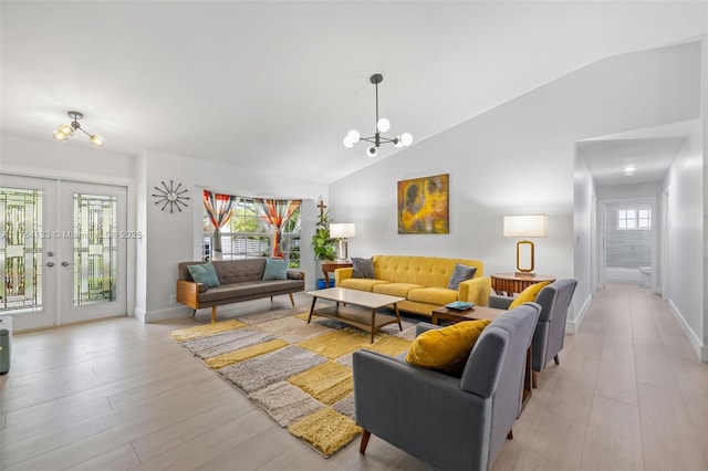 living room featuring light wood finished floors, baseboards, vaulted ceiling, french doors, and a notable chandelier