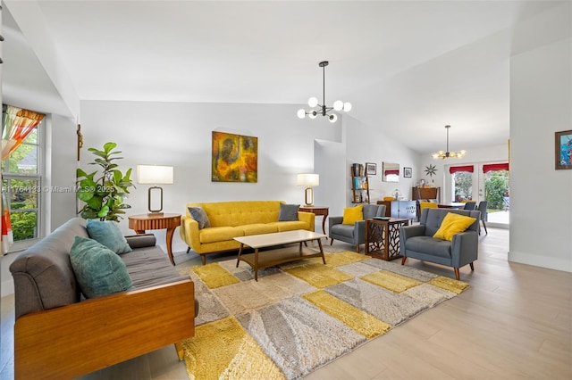 living room featuring baseboards, a chandelier, french doors, wood finished floors, and high vaulted ceiling