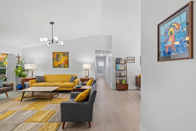 living area with a chandelier, high vaulted ceiling, light wood-type flooring, and baseboards