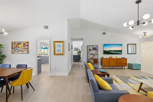 living area featuring vaulted ceiling, light wood-style flooring, a notable chandelier, and visible vents