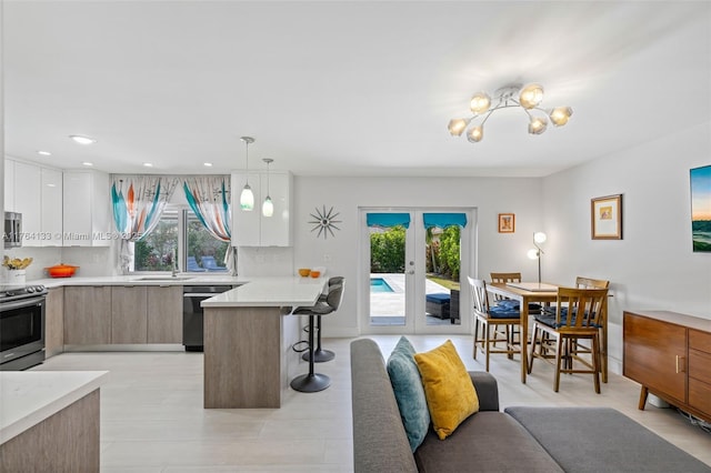 interior space featuring a notable chandelier, recessed lighting, and french doors