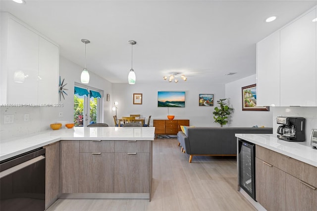 kitchen with dishwashing machine, light stone countertops, a peninsula, wine cooler, and modern cabinets