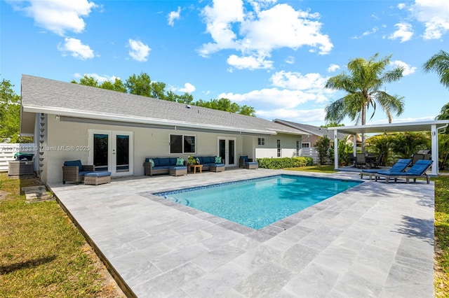 outdoor pool with a patio area, french doors, an outdoor hangout area, and fence