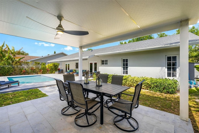 view of patio with a ceiling fan, outdoor dining space, french doors, and a fenced in pool