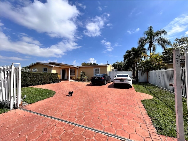 view of front of home with fence and stucco siding