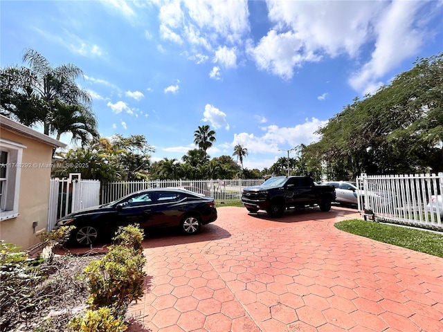 view of parking / parking lot featuring fence