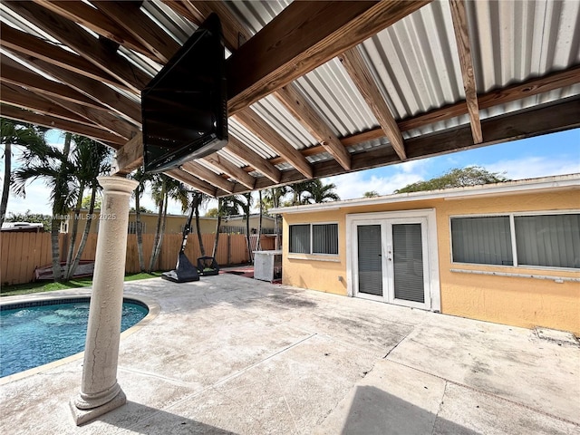 view of patio / terrace featuring french doors, a fenced in pool, and fence